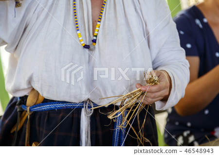 Russian woman weaves the toy for child Russian woman weaves the toy for child 46548943