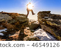 man jumps among the rocks 46549126