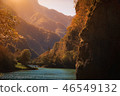 fisherman in a mountain lake, autumn landscape 46549132