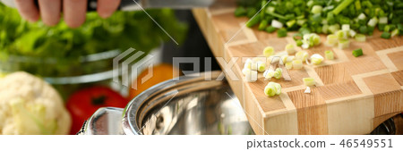 Cook holds knife in hand and cuts on 46549551