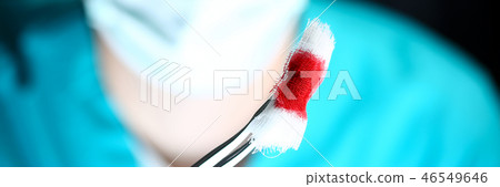 Surgeon in sterile uniform arms holding tools with bio material Surgeon in sterile uniform arms holding tools with bio material 46549646