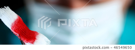 Surgeon in sterile uniform arms holding tools with bio material Surgeon in sterile uniform arms holding tools with bio material 46549650