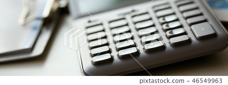 Silver calculator with gray keyboard is lying Silver calculator with gray keyboard is lying 46549963