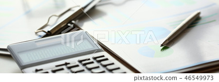 Silver calculator with gray keyboard is lying Silver calculator with gray keyboard is lying 46549973