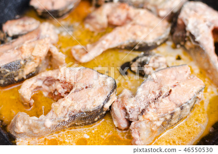 Stewed red salmon fish in tomato sauce 46550530