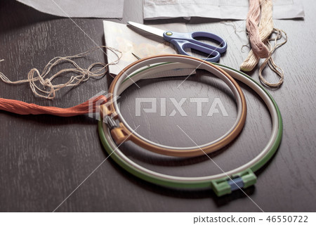 Horizontal shot of the embroidery kit close-up on a wooden table. 46550722