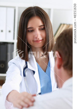 Friendly female doctor hold patient shoulder 46551630