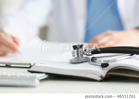 Stethoscope head lying on medical forms Stethoscope head lying on medical forms 46551761