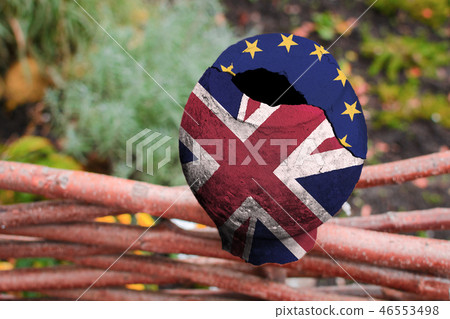 A broken pottery is painted in the colors of the UK and the European Union on the fence of wood. A broken pottery is painted in the colors of the UK and the European Union on the fence of wood. 46553498