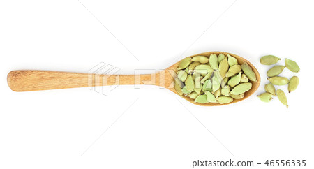 Green cardamom seeds in wooden spoon isolated on white background. Top view. lay flat 46556335