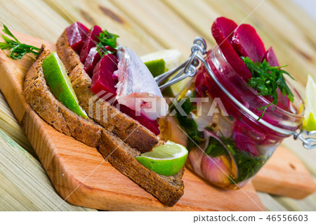 Pickled whiting in homemade marinade with beets Pickled whiting in homemade marinade with beets 46556603