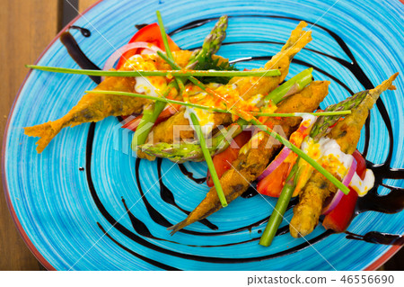 Battered anchovies with sauce and vegetables Battered anchovies with sauce and vegetables 46556690