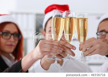A group of businesspeople celebrating Christmas A group of businesspeople celebrating Christmas 46556716