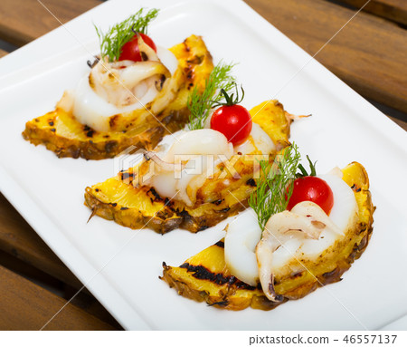 Cooked at grill sepia with pineapple, cherry tomatoes and with sweet-sour sauce 46557137