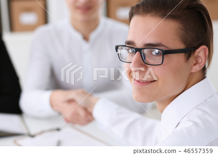 Smiling man in shirt shake hands hello in office Smiling man in shirt shake hands hello in office 46557359