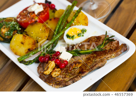 Veal with baked vegetables is tasty dish Veal with baked vegetables is tasty dish 46557369