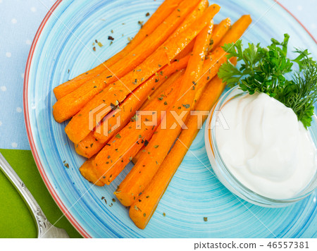 Image of carrot sticks deep fried and served with sour cream at plate Image of carrot sticks deep fried and served with sour cream at plate 46557381