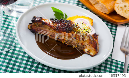 Roasted pork ribs in chocolate sauce with baked potatoes Roasted pork ribs in chocolate sauce with baked potatoes 46557493