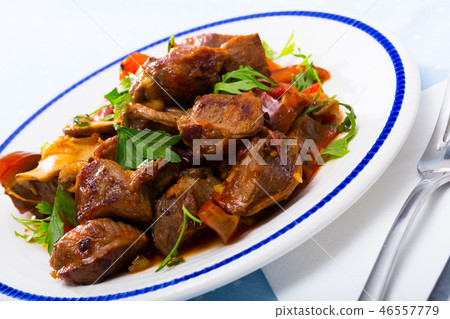 Delicious fried pork with button mushroom, peppers and greens Delicious fried pork with button mushroom, peppers and greens 46557779