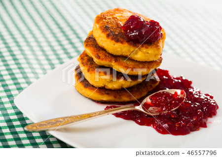 Image of stack of fried quark pancakes with jam served 46557796