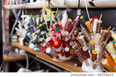 Spools of thread and laces at sewing atelier Spools of thread and laces at sewing atelier 46558014