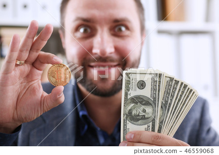 Young happy smiling businessman holding Young happy smiling businessman holding 46559068