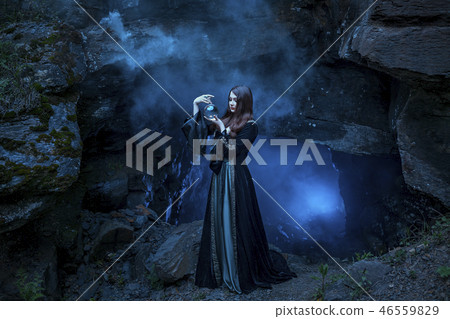 The witch with magic ball in her hands causes a spirits The witch with magic ball in her hands causes a spirits 46559829