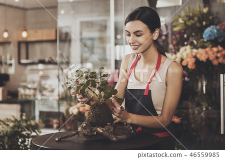 Portrait of beautiful girl florist in flower shop 46559985