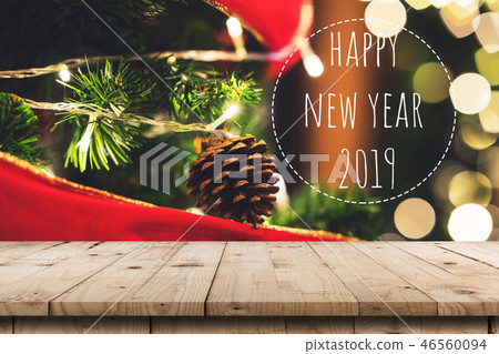 Empty wood table and christmas pine cones hanging 46560094