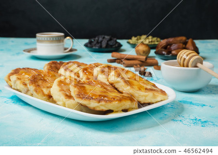 Msabeeb is a flatbread. Arabic dessert with honey. Msabeeb is a flatbread. Arabic dessert with honey. 46562494
