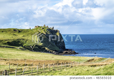 The castle ruins next to Tulm Island at Duntulm Bay on the Isle of Skye - Scotland The castle ruins next to Tulm Island at Duntulm Bay on the Isle of Skye - Scotland 46565010