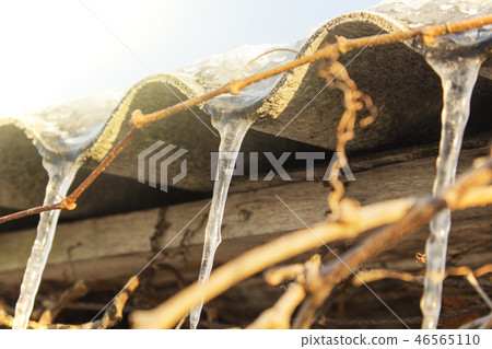 icicles which are hanging down from a roof icicles which are hanging down from a roof 46565110