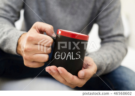 man with a mug with the word goals 46568602