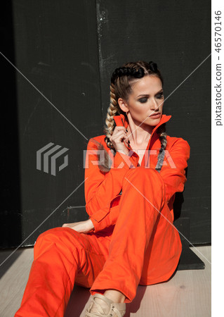 beautiful fashionable woman with braids in Orange overalls beautiful fashionable woman with braids in Orange overalls 46570146