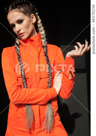 beautiful fashionable woman with braids in Orange overalls beautiful fashionable woman with braids in Orange overalls 46570156