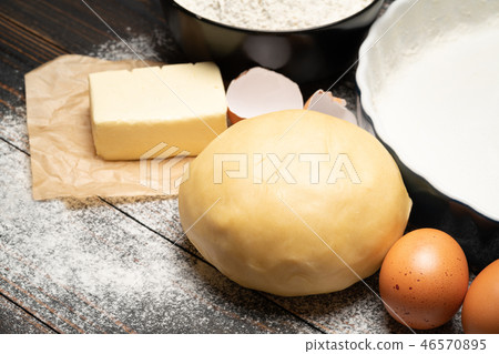 unrolled and unbaked Shortcrust pastry dough recipe on wooden background unrolled and unbaked Shortcrust pastry dough recipe on wooden background 46570895