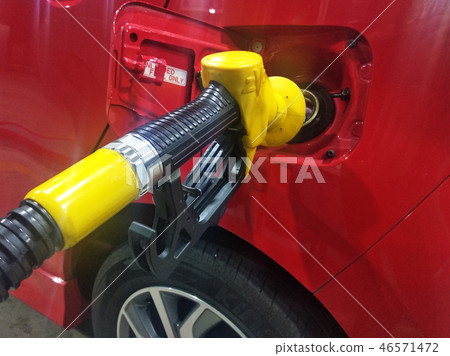 Petrol nozzle used to pumping petrol into the car Petrol nozzle used to pumping petrol into the car 46571472