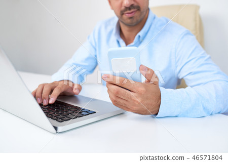 Businessman sitting at his workplace Businessman sitting at his workplace 46571804