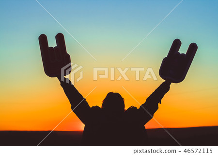 Hands with horns raised up in the standing  46572115
