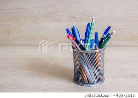 Pens and pencils in metal stand 46572518