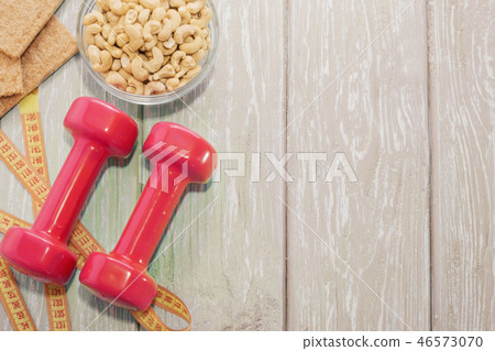 The concept of a healthy diet. Small dumbbells 46573070