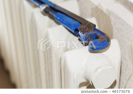 A big rusty key, radiator repair. 46573078
