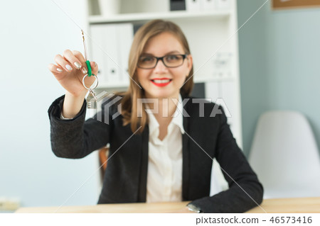 New home and real estate concept - Happy realtor woman giving you keys New home and real estate concept - Happy realtor woman giving you keys 46573416