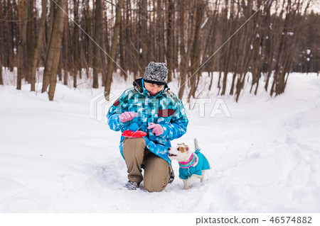 Middle aged woman outdoors with cute dog - Jack Russell Terrier in winter season Middle aged woman outdoors with cute dog - Jack Russell Terrier in winter season 46574882
