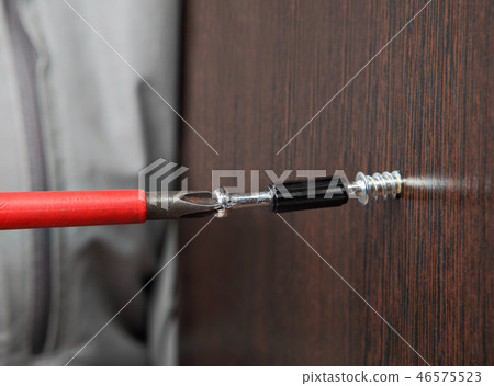 screw wrapped in wooden plank close up 46575523