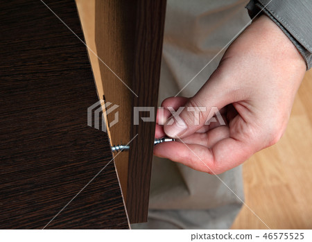 Hand screws in hole chipboard, furniture assembly 46575525