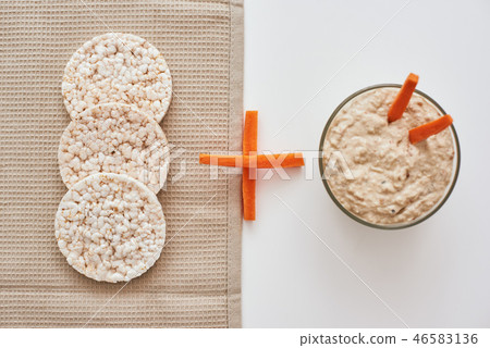Hummus with carrot sticks. Top view oh humus with carrot isolated on white background. 46583136