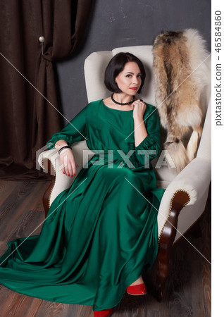 woman in a silk green dress posing sitting woman in a silk green dress posing sitting 46584860