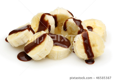 Banana slices topped with chocolate syrup 46585387