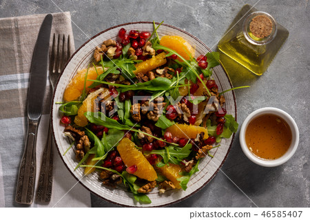 Arugula salad with oranges, walnuts and pomegranat Arugula salad with oranges, walnuts and pomegranat 46585407
